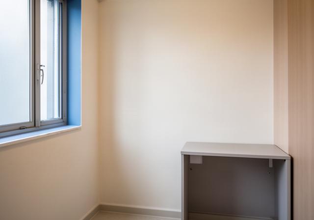 Compact HDB bedroom corner before workspace setup, with a clear wall beside a window and limited floor area